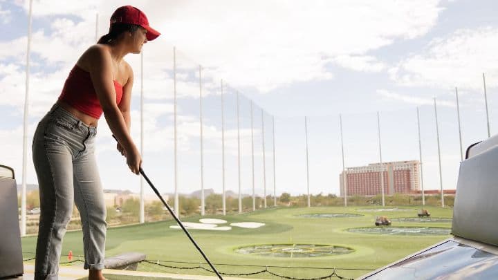Golfer addressing the ball at a multi-level driving range