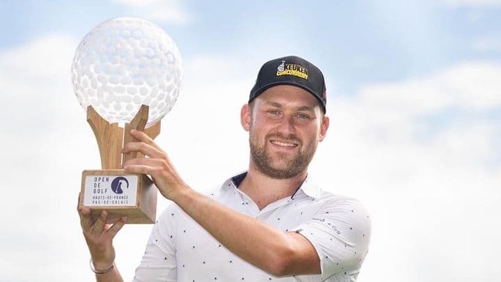 Davey Porsius holding a golfing trophy